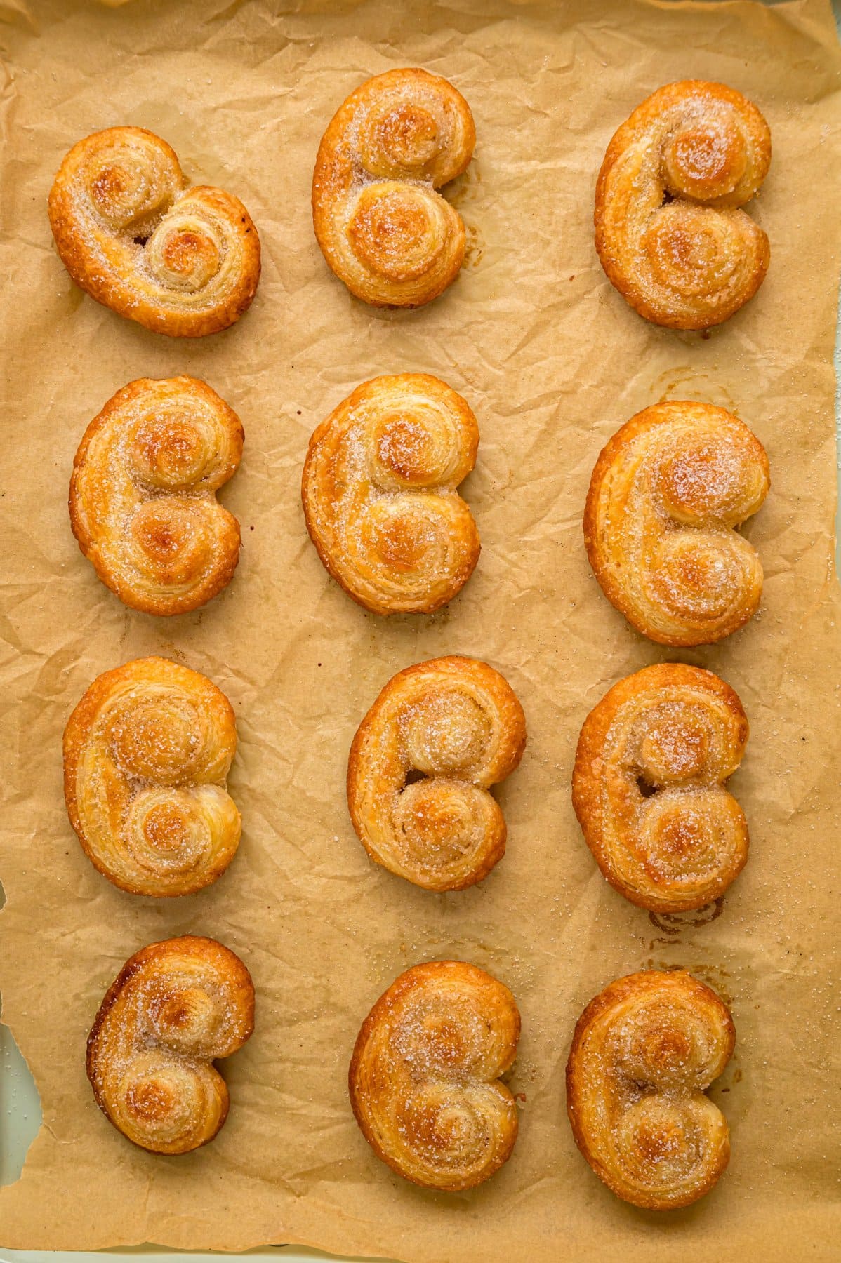 Overhead view of a baking sheet of palmiers
