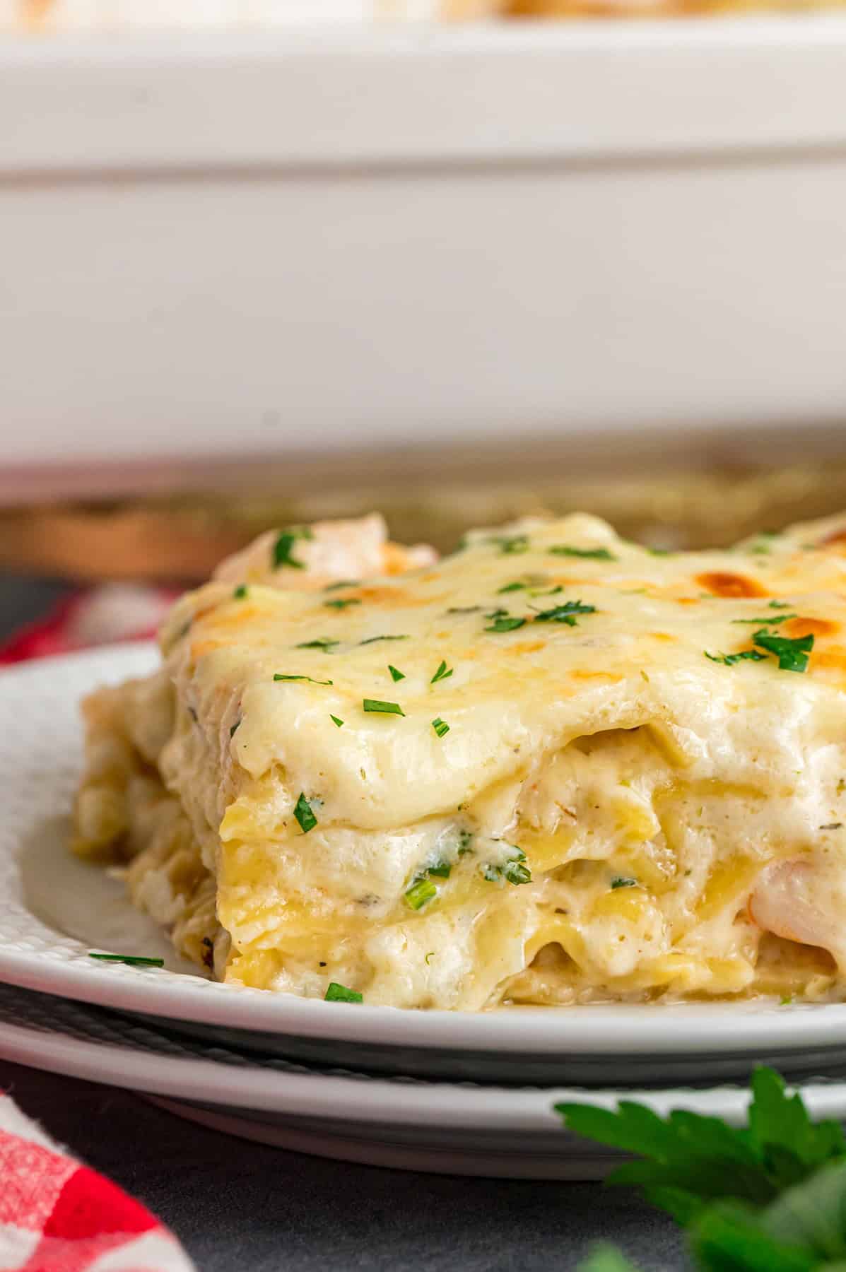 A plate with a slice of seafood lasagna