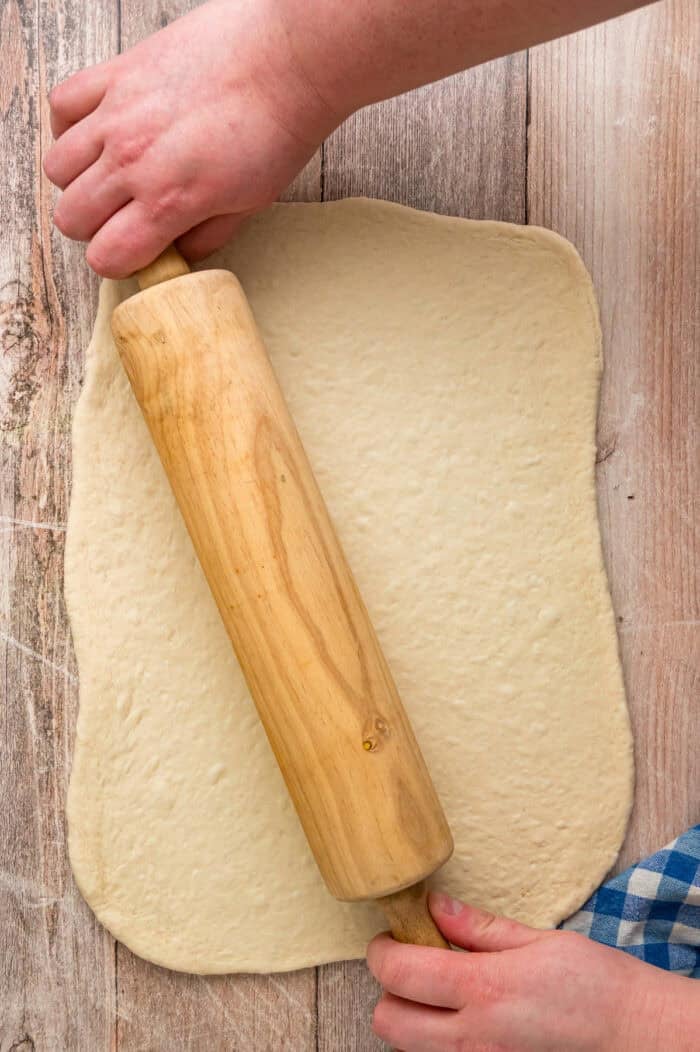 Rolling pizza dough into a rectangle