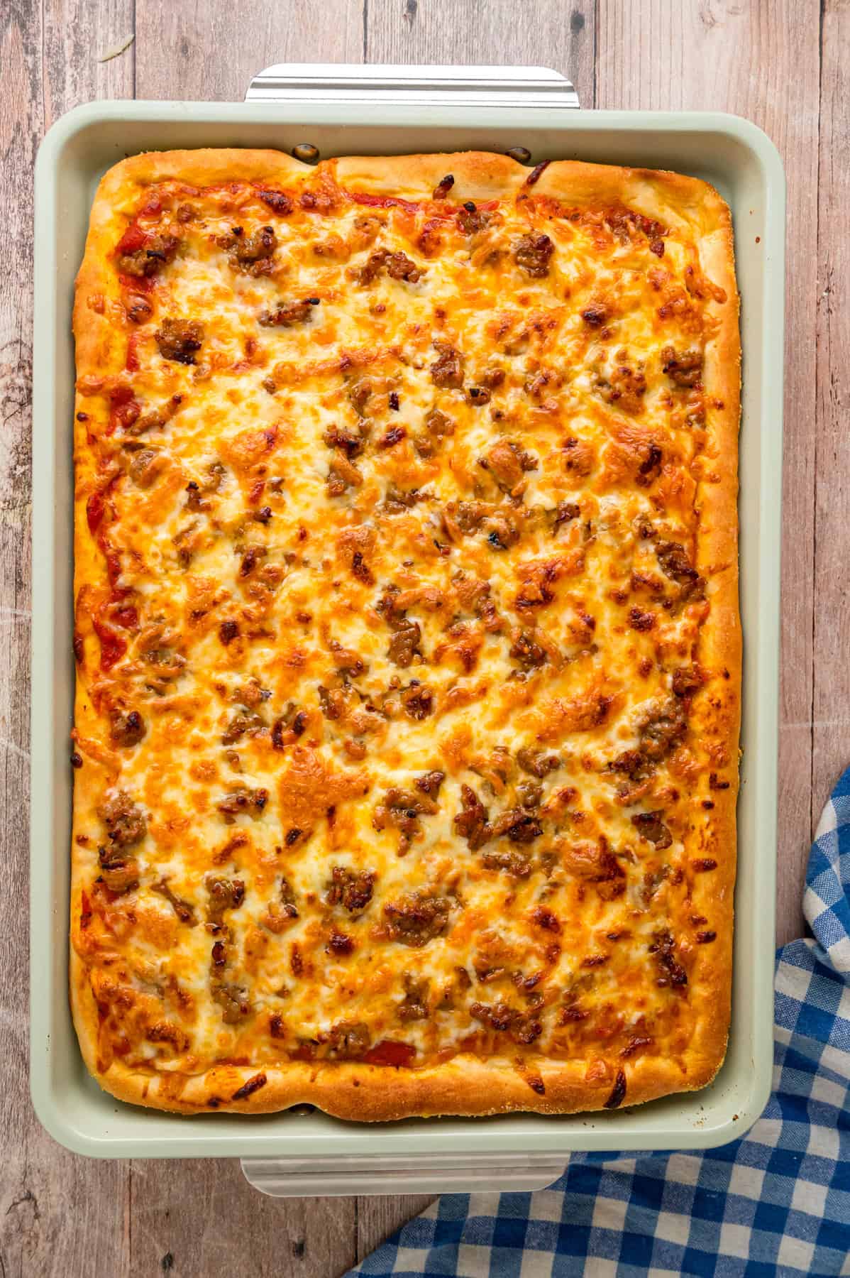 Overhead view of a sausage sheet pan pizza