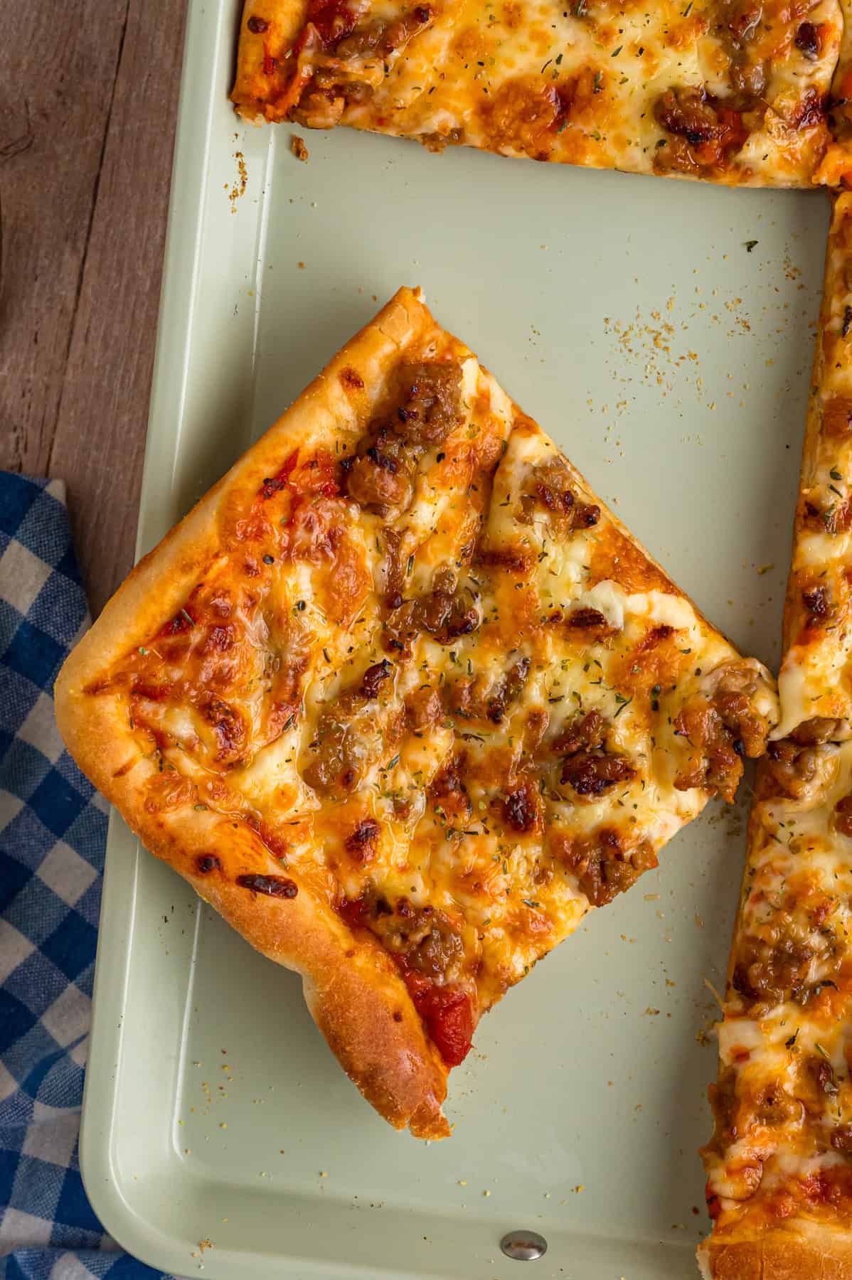 Overhead view of a slice of sheet pan pizza on the baking sheet