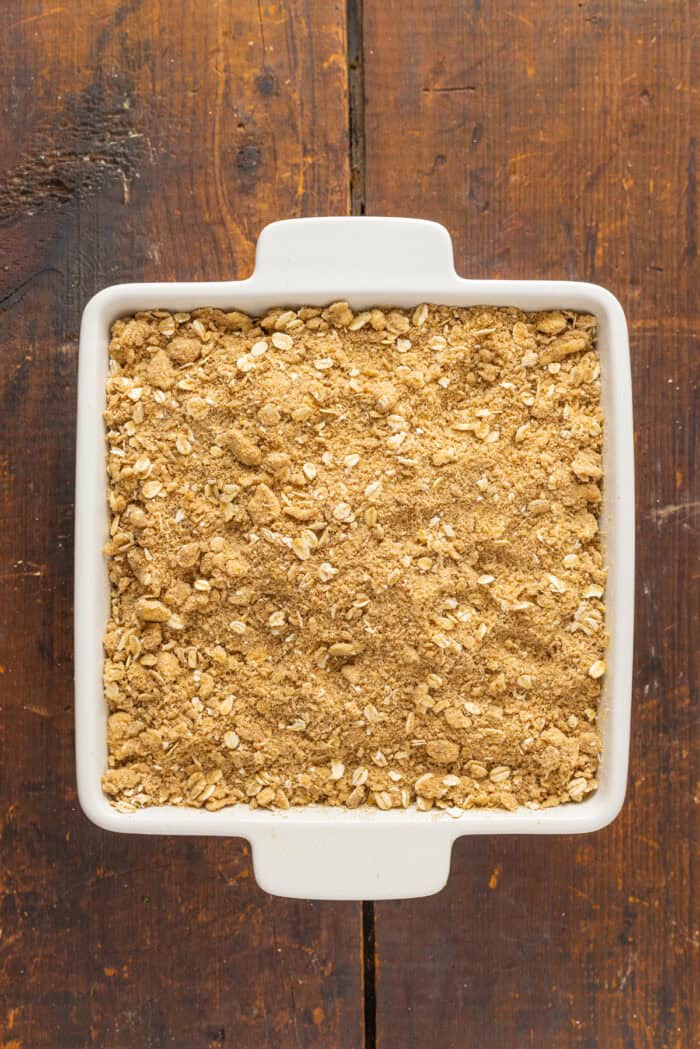 Warmly spiced fresh peaches are topped with a crumble topping in this Peach Crisp recipe. Serve with ice cream for a quick & easy dessert! Crumb topping in a baking dish