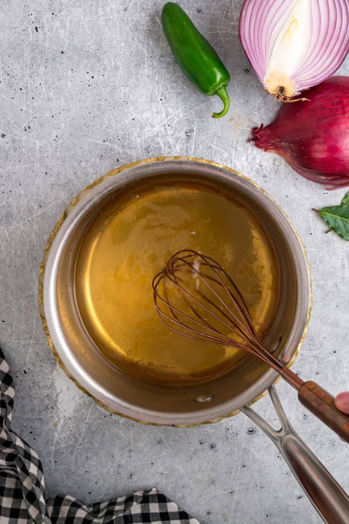 Whisking pickling vinegar in a saucepan