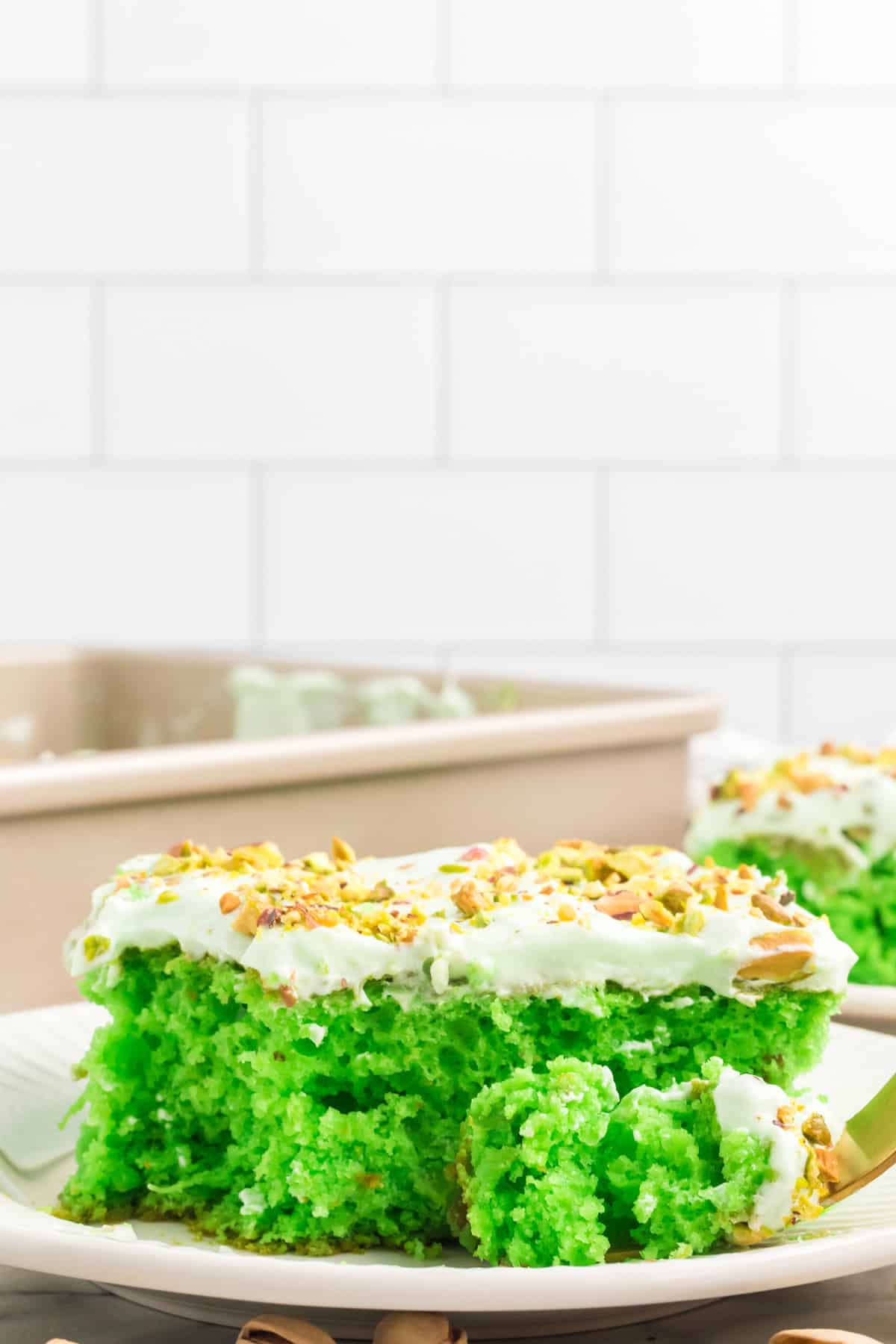 A slice of pistachio cake on a plate