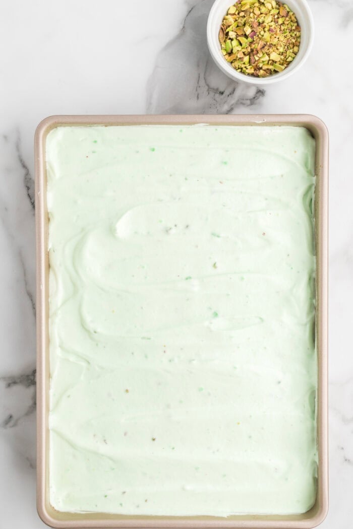 Pistachio frosting on a cake