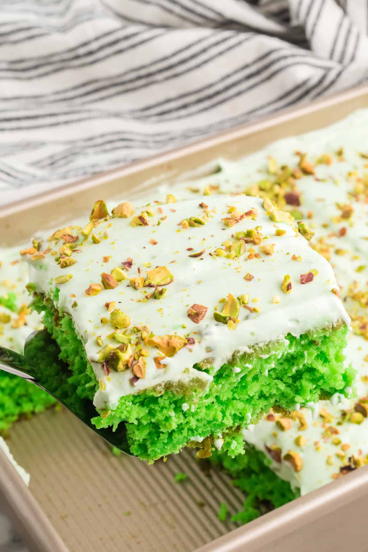 Serving a slice of pistachio cake