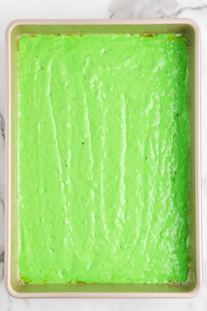 Pistachio batter in a cake pan
