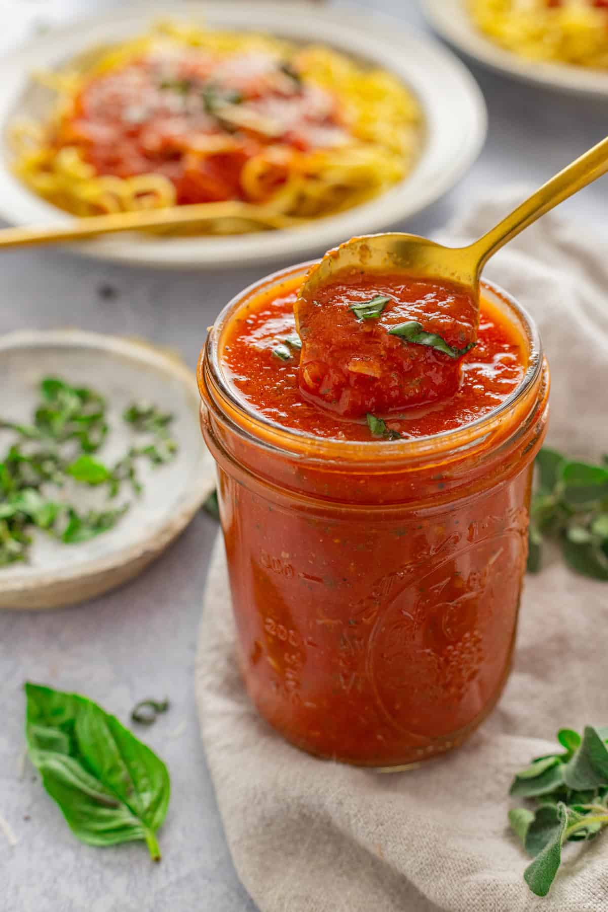 Made with canned tomatoes, garlic, and a few spices, this Pomodoro Sauce is proof that sometimes simple is best. A spoon in a jar of pomodoro sauce