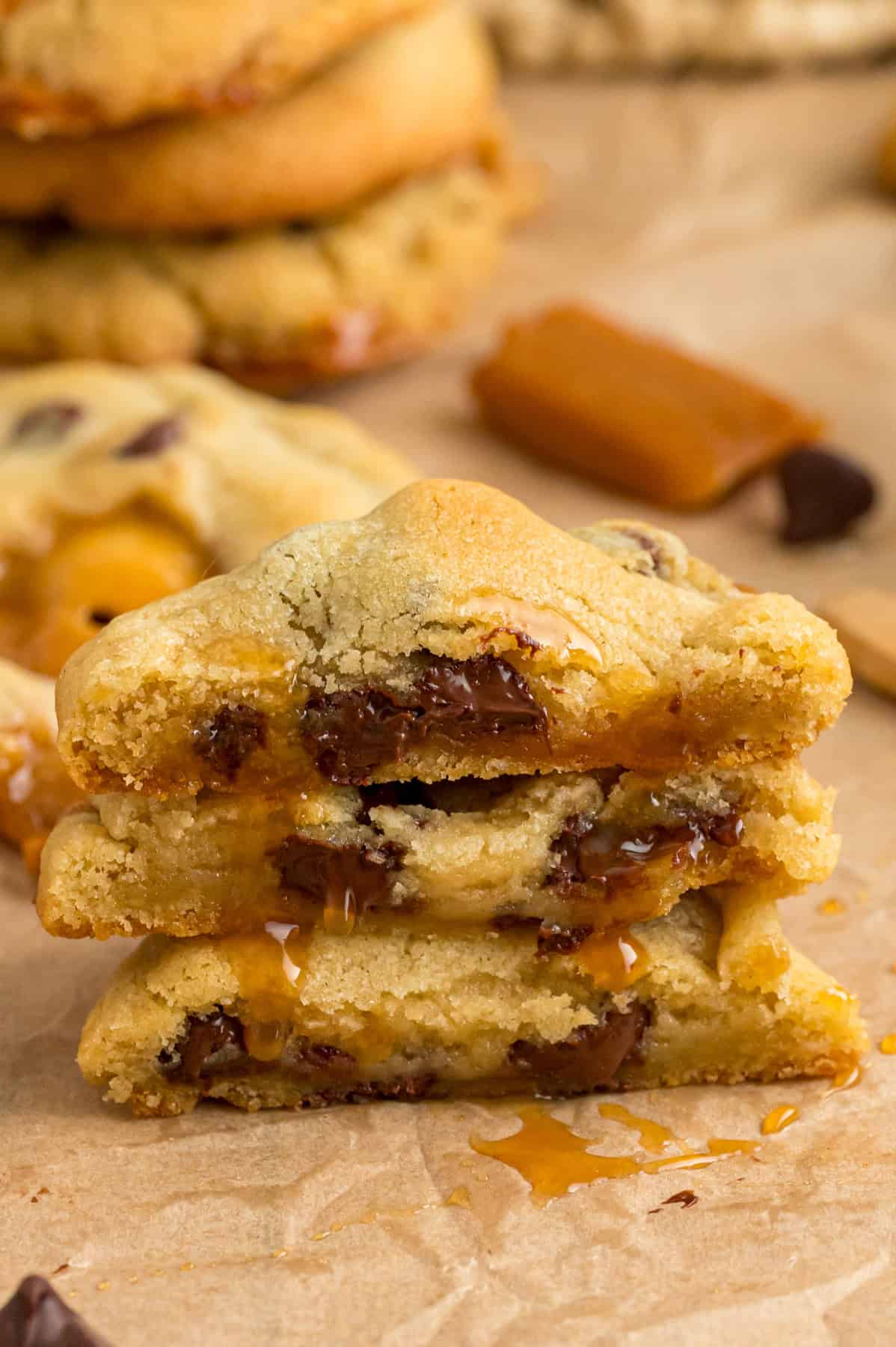 A stack of caramel chocolate chip cookies cut in half