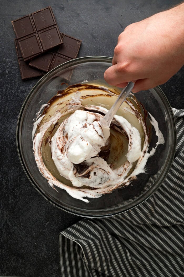 Folding whipped egg whites into melted chocolate
