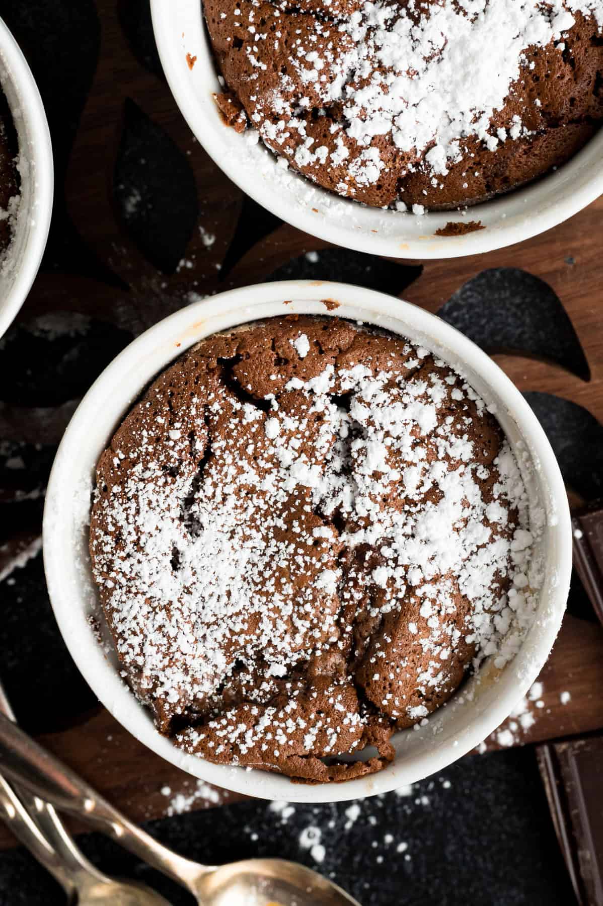 Rich, creamy, and decadent, this Chocolate Souffle recipe requires no special skills or tools. Perfect for special occasions! Overhead view of chocolate souffle topped with powdered sugar