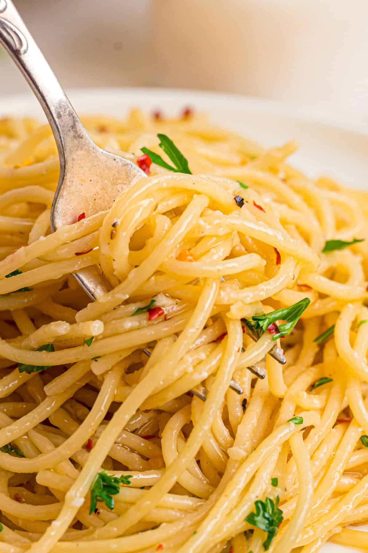 A fork twirling garlic butter noodles