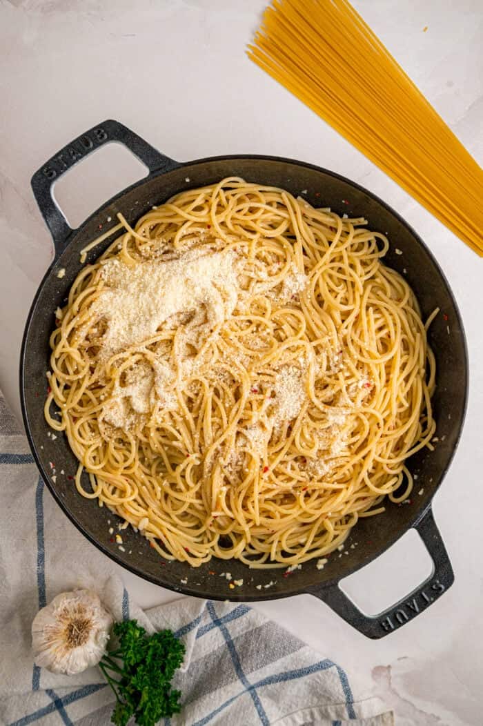 Adding parmesan cheese to noodles