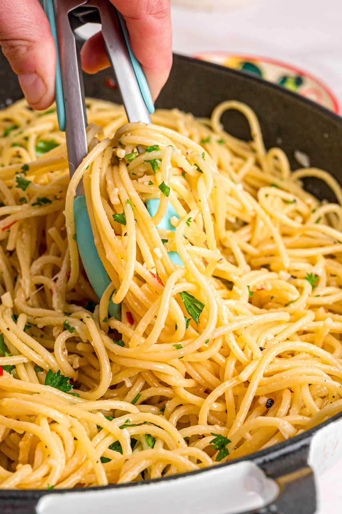 This Garlic Butter Noodles recipe elevates a childhood classic into a buttery, flavorful pasta dish perfect for any night of the week. Tongs in garlic butter noodles