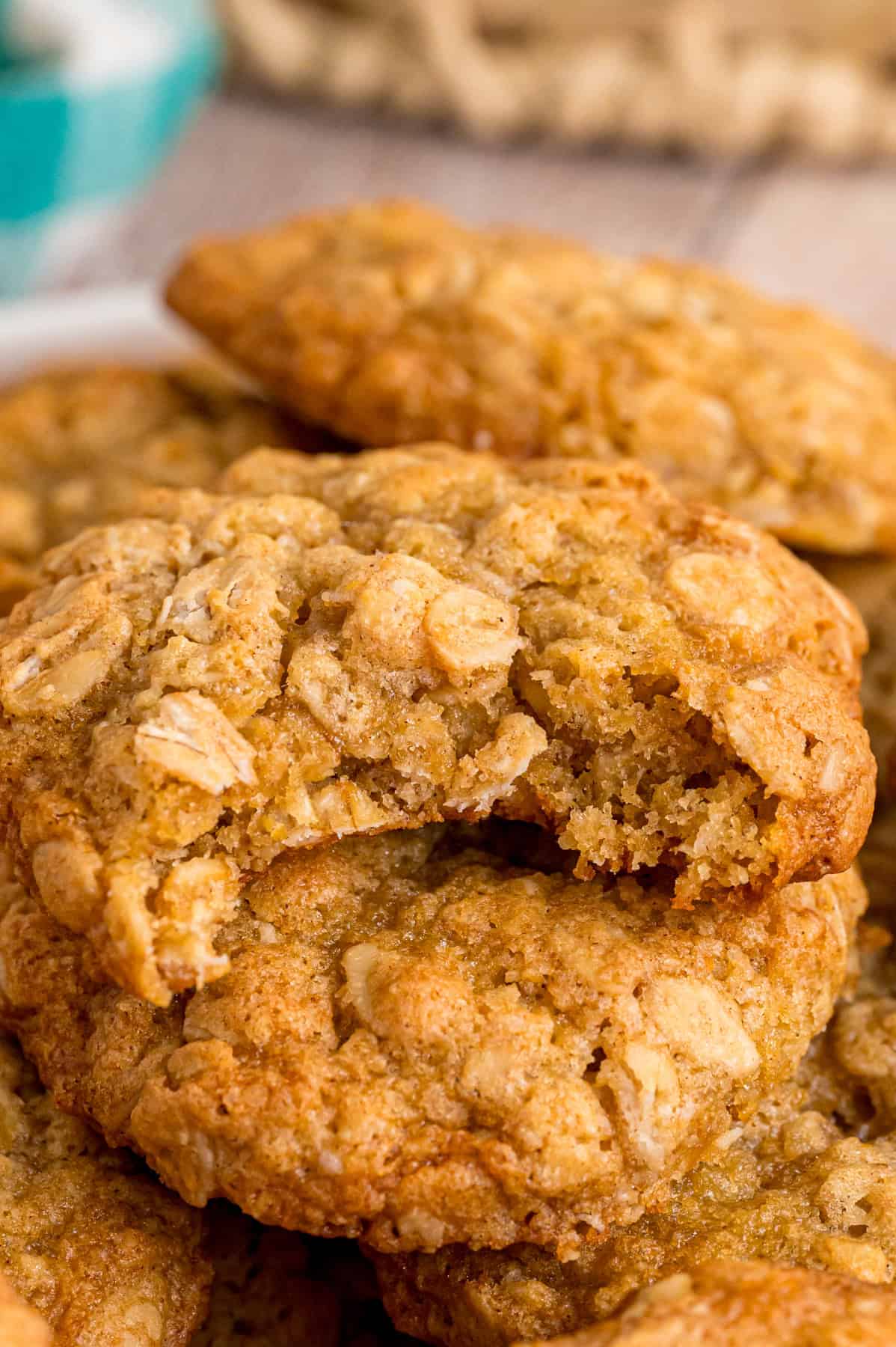 These Soft Oatmeal Cookies are chewy on the edges and super soft in the center, with a warm flavor thanks to the cinnamon and brown sugar. Close up of a plate of soft oatmeal cookies, one with a bite missing