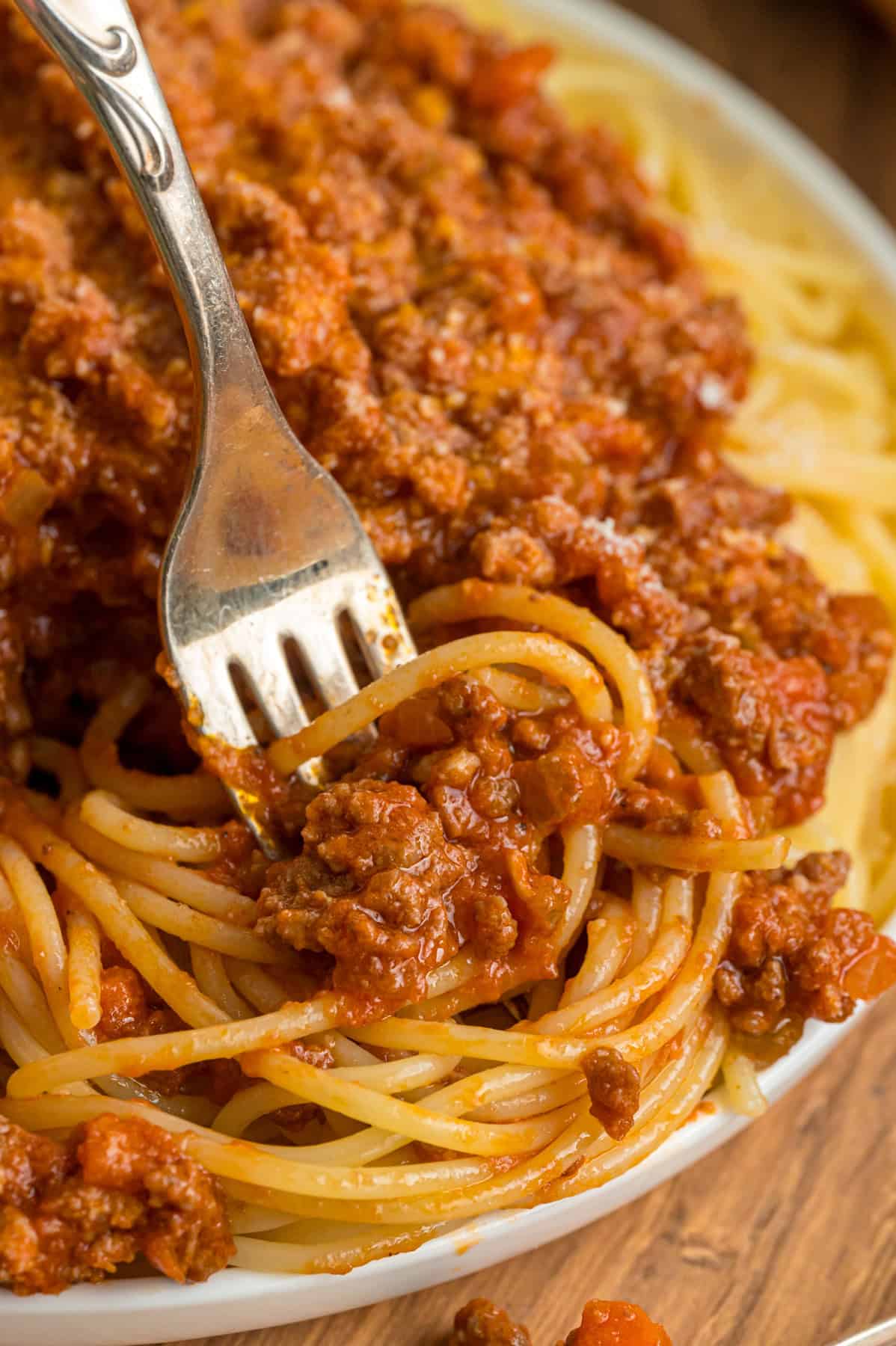 A fork twirling spaghetti bolognese