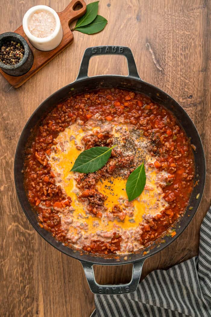 Cream and bay leaves added to spaghetti meat sauce