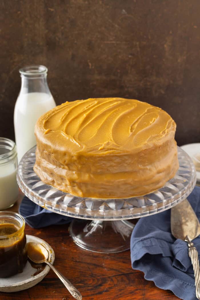 A caramel layer cake on a cake stand