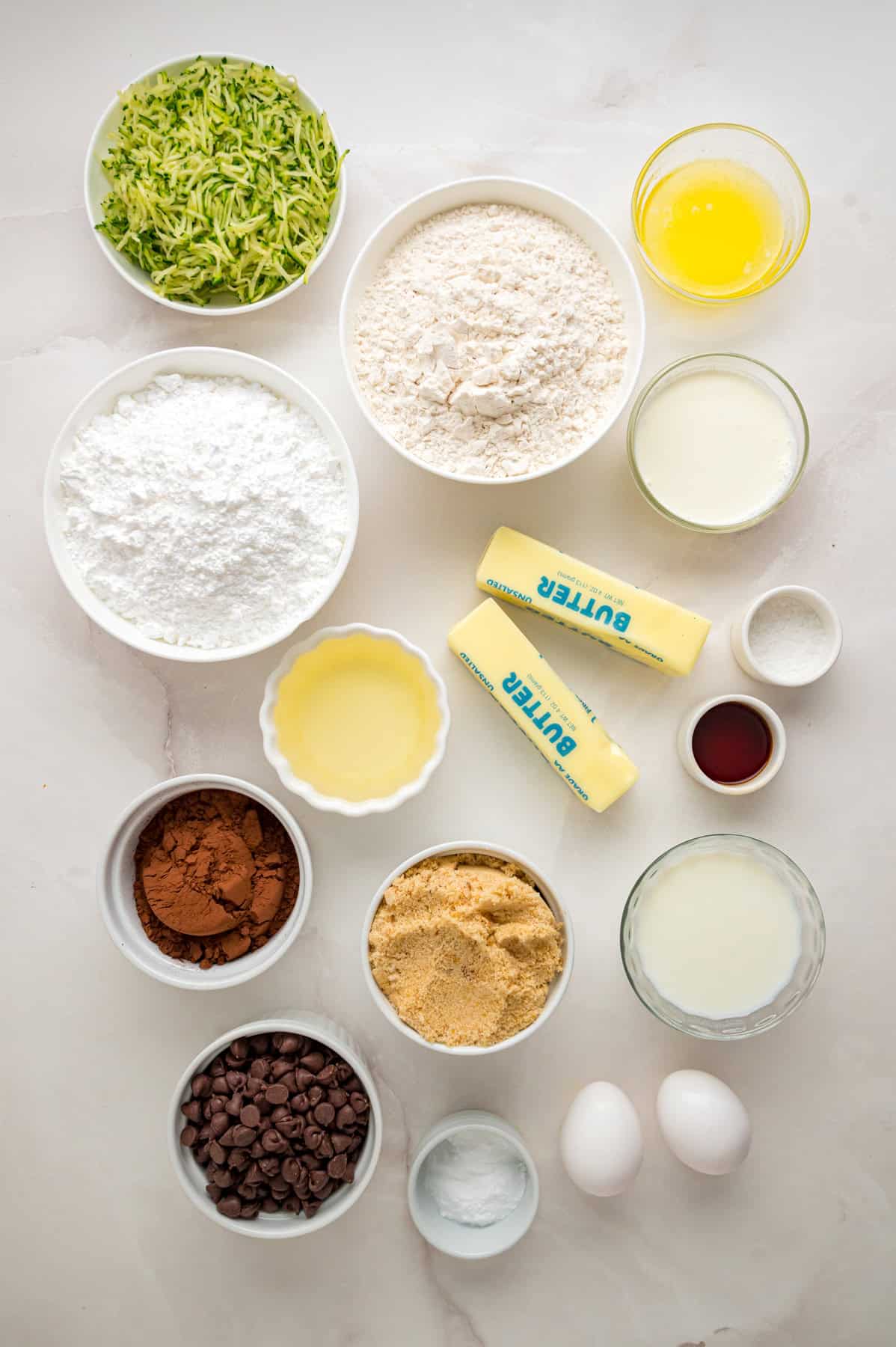This Chocolate Zucchini Cake is rich, moist, and topped with an irresistible chocolate buttercream! It's a must-bake every summer! Overhead view of ingredients for chocolate zucchini cake