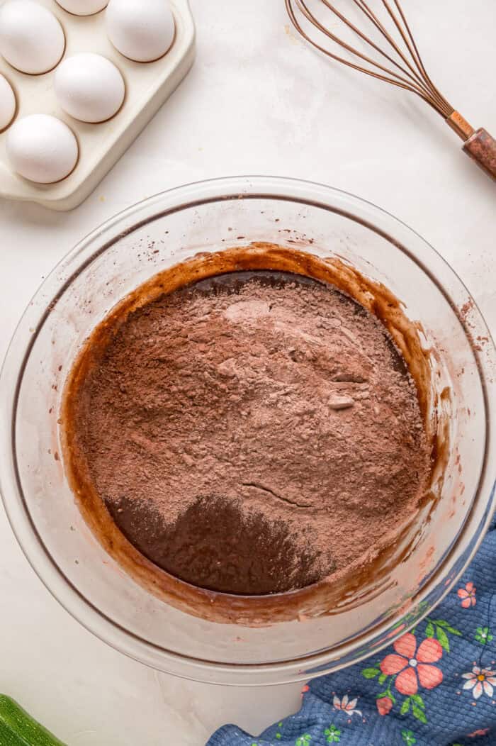 This Chocolate Zucchini Cake is rich, moist, and topped with an irresistible chocolate buttercream! It's a must-bake every summer! Combining wet and dry cake ingredients