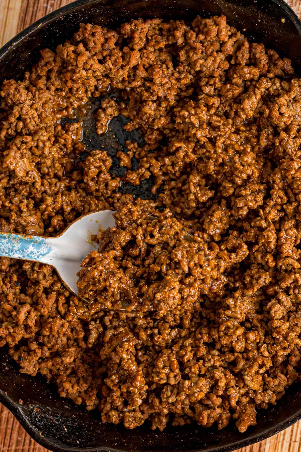 A spoon in seasoned ground beef