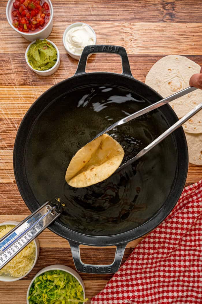 Frying a tortilla in taco shape