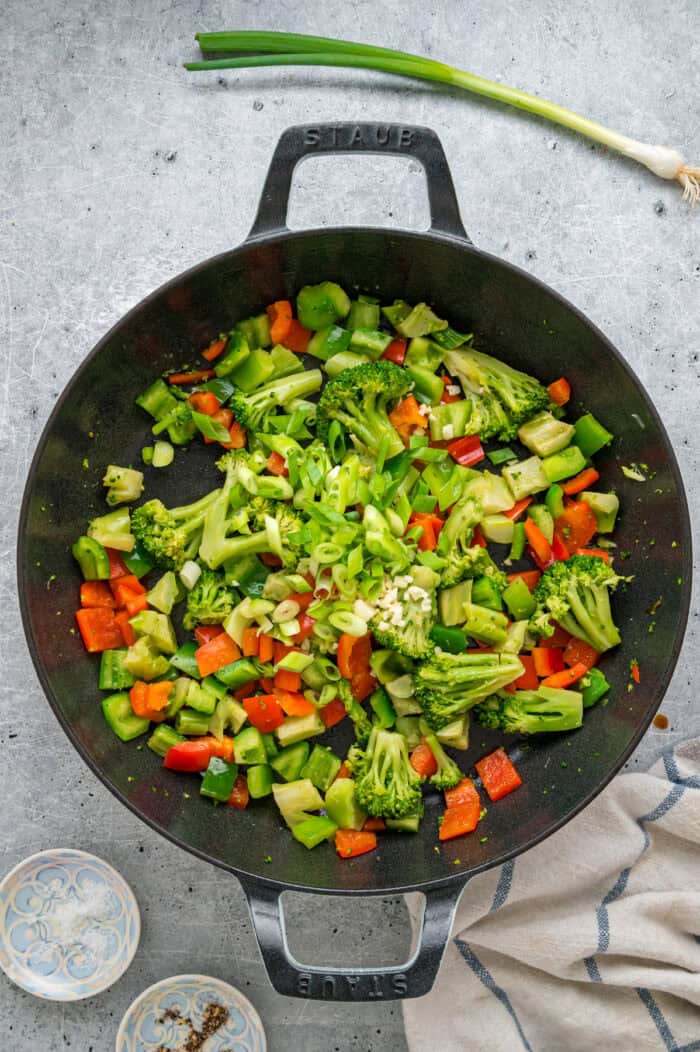 Cooking broccoli and bell peppers in a skillet