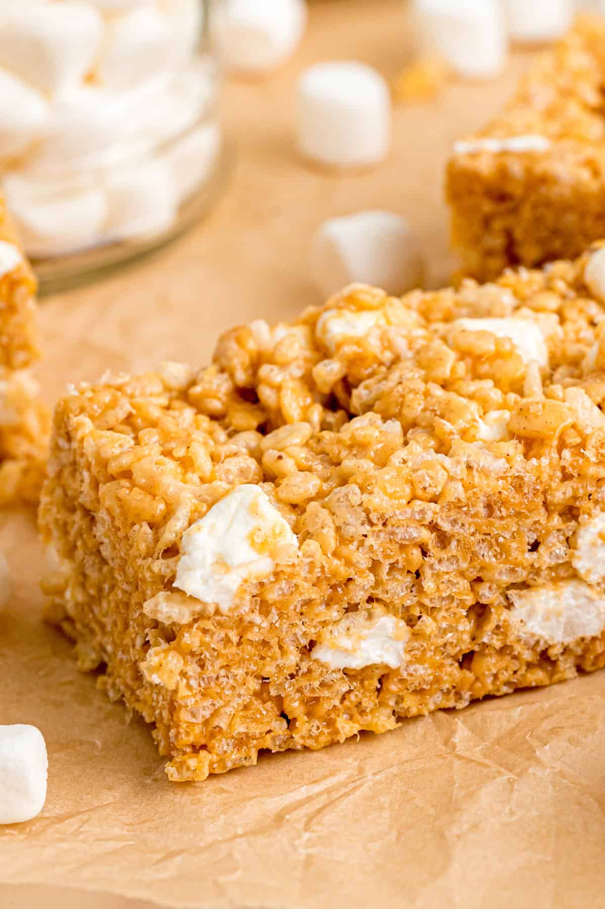 A peanut butter rice krispie treat on a cutting board
