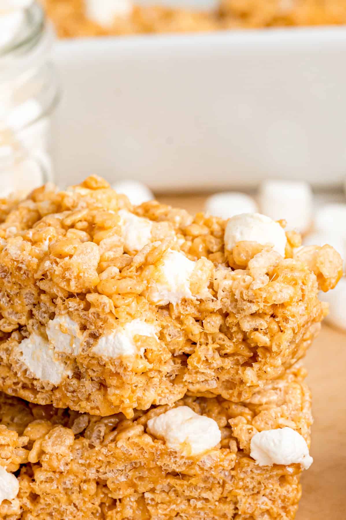 Two peanut butter rice krispie treats, one with a bite missing