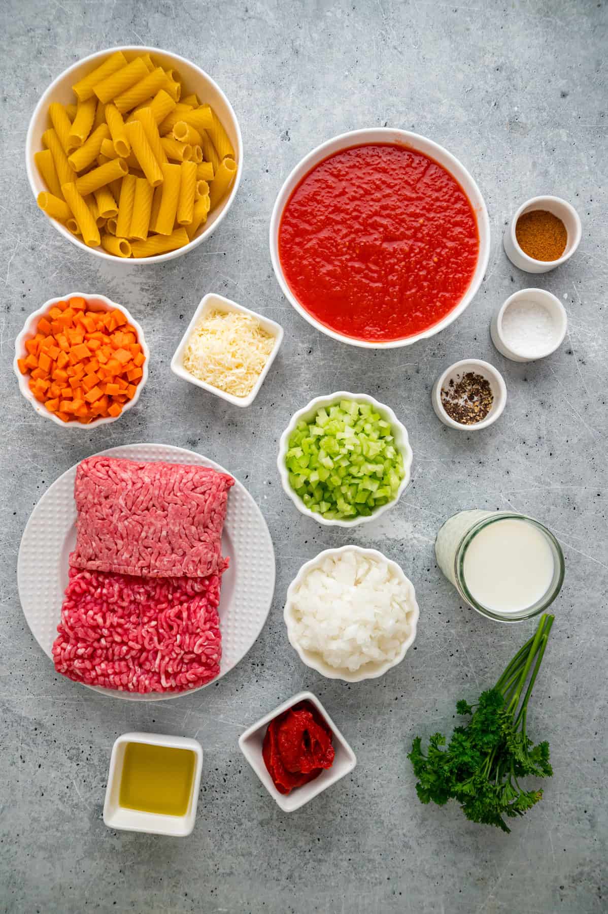 Overhead view of ingredients needed to make rigatoni bolognese