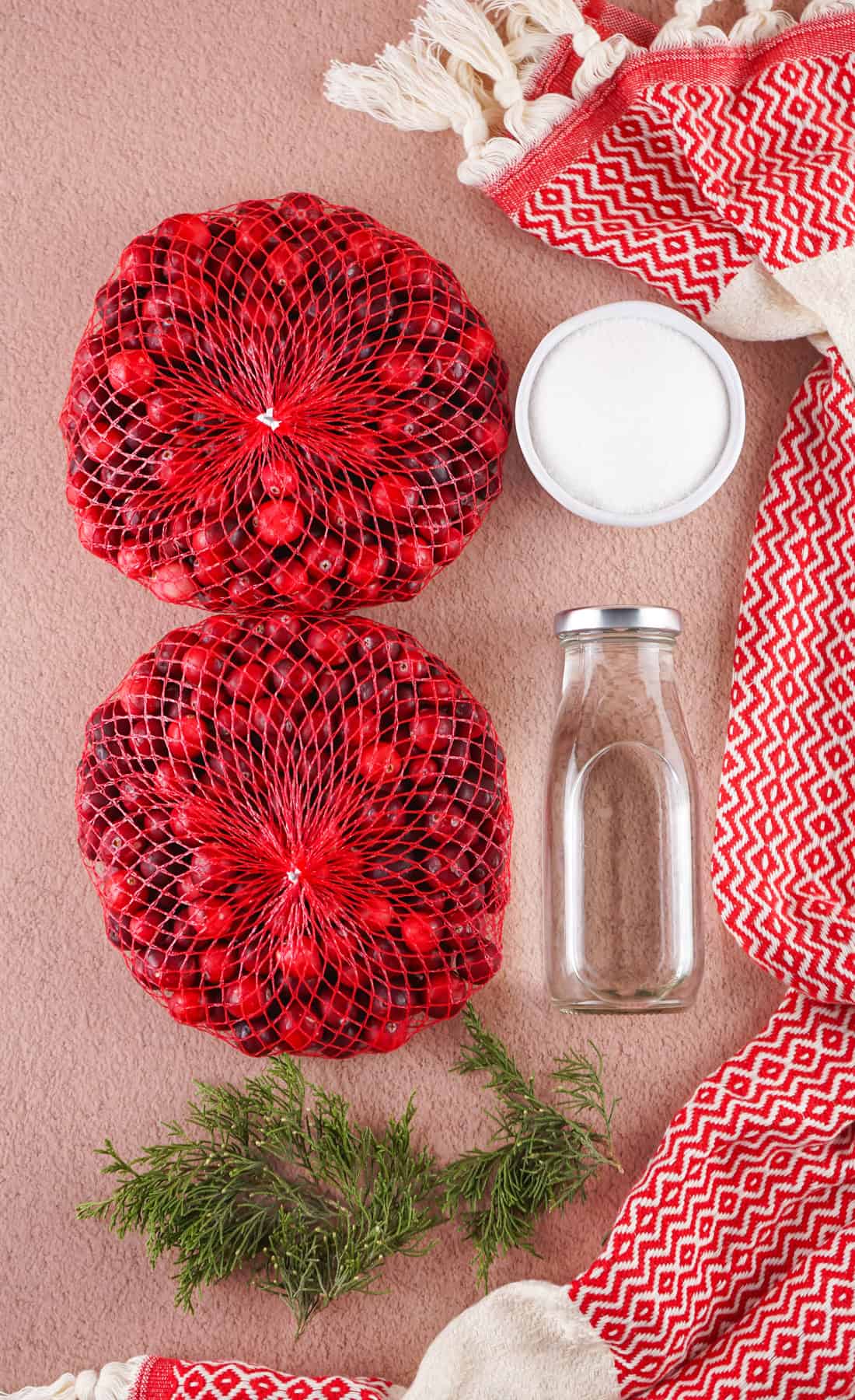 Sugared Cranberries are a gorgeous and easy holiday treat that can be used as a garnish or decoration, or simply a snack! Overhead view of cranberries, sugar, and water.