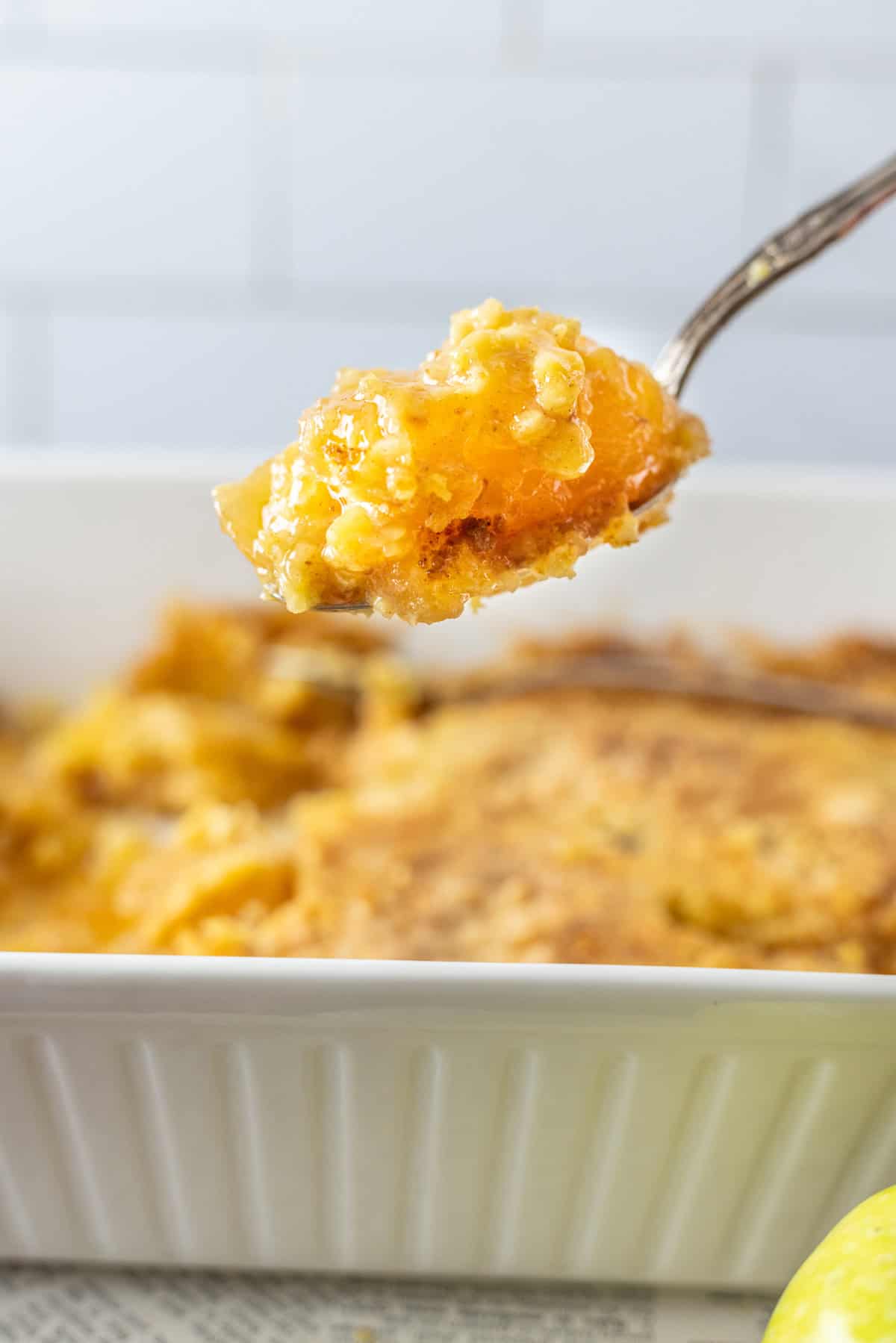 A spoon serving apple dump cake