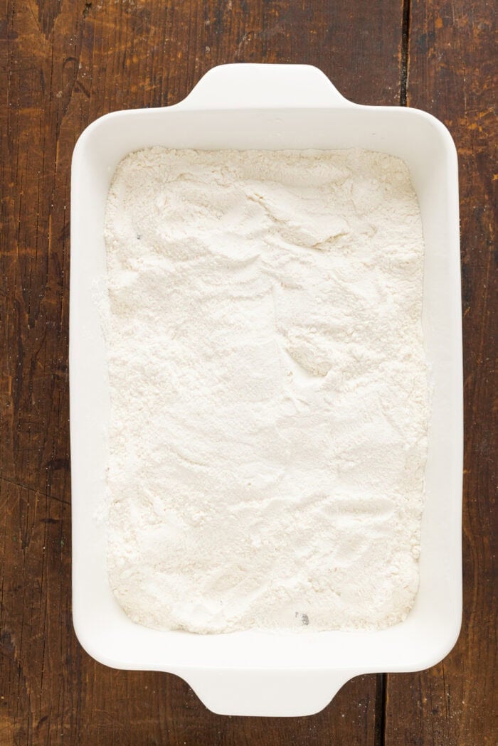 Yellow cake mix over apple pie filling in a baking dish