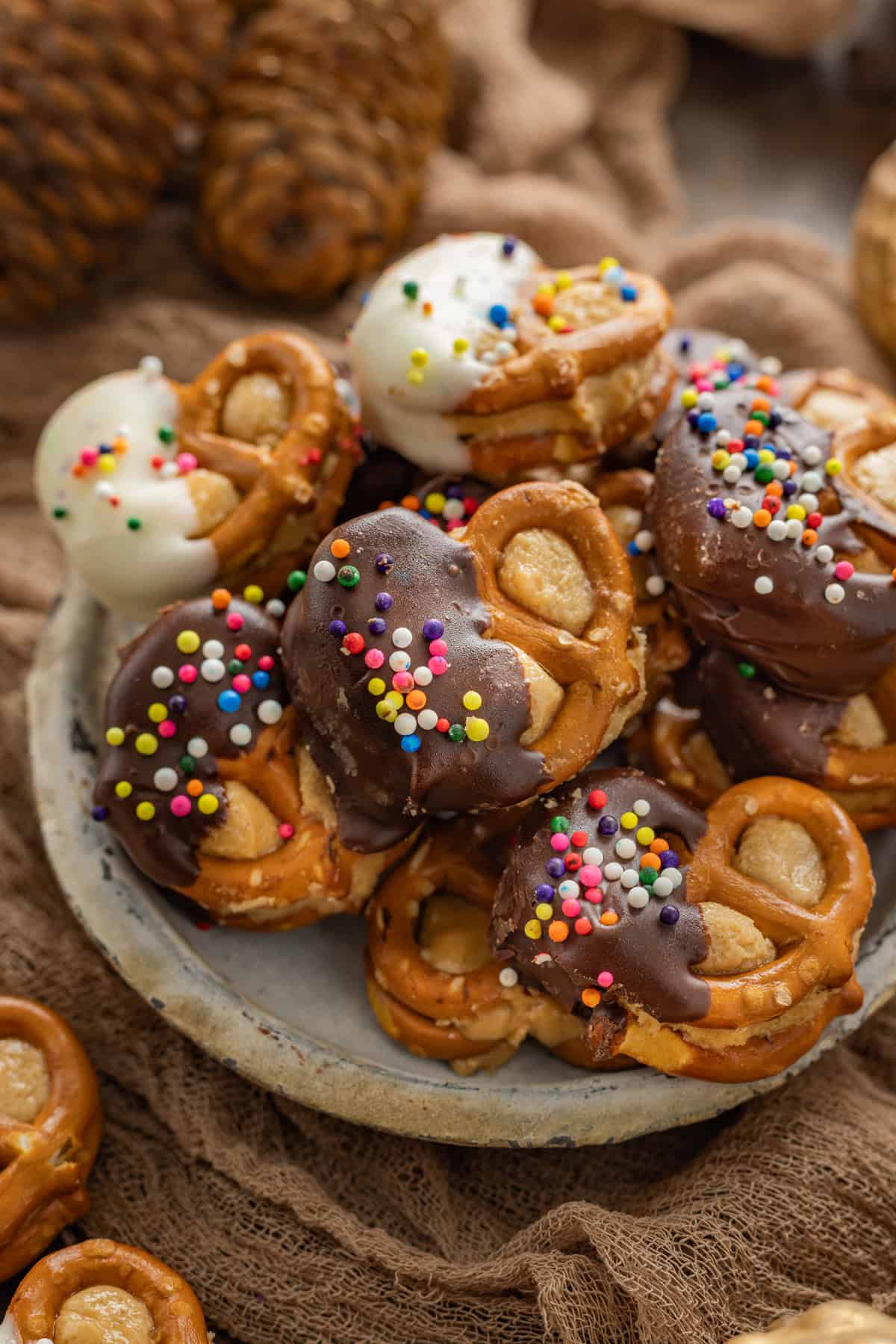 These Peanut Butter Pretzel Bites feature pretzel sandwiches filled with a creamy, sweet peanut butter mixture and dipped in chocolate. A plate of peanut butter pretzel bites