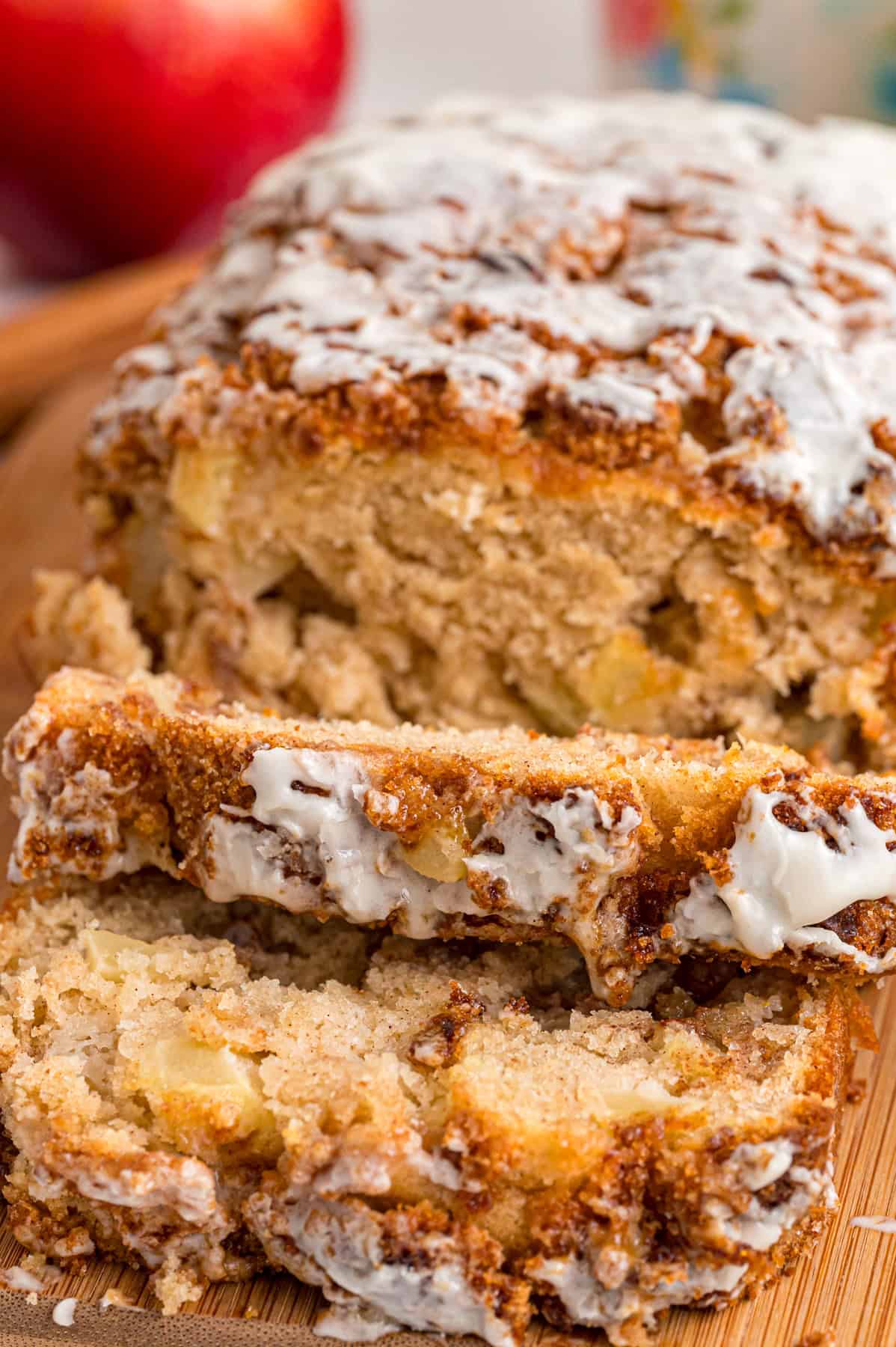 A loaf of apple cinnamon bread with a few pieces sliced
