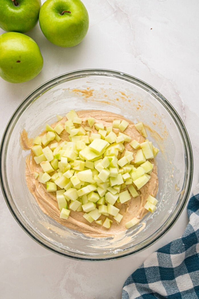Folding apples into cinnamon bread batter