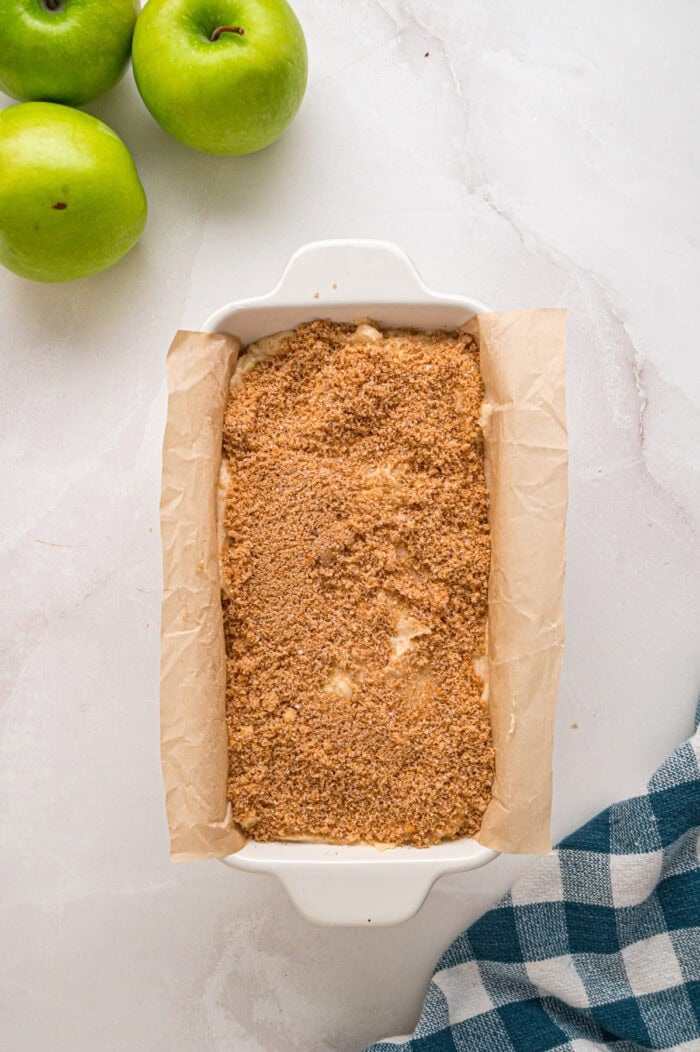 Cinnamon sugar over bread batter in a loaf pan
