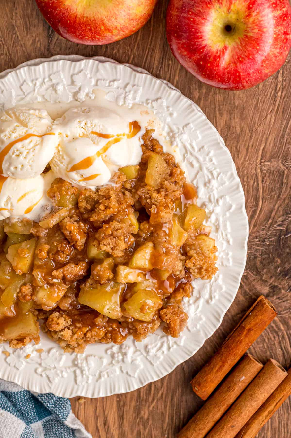 Overhead view of a plate of apple crumble with vanilla ice cream