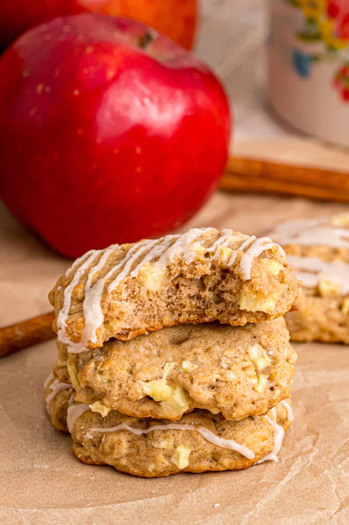 Three apple oatmeal cookies stacked with one missing a bite