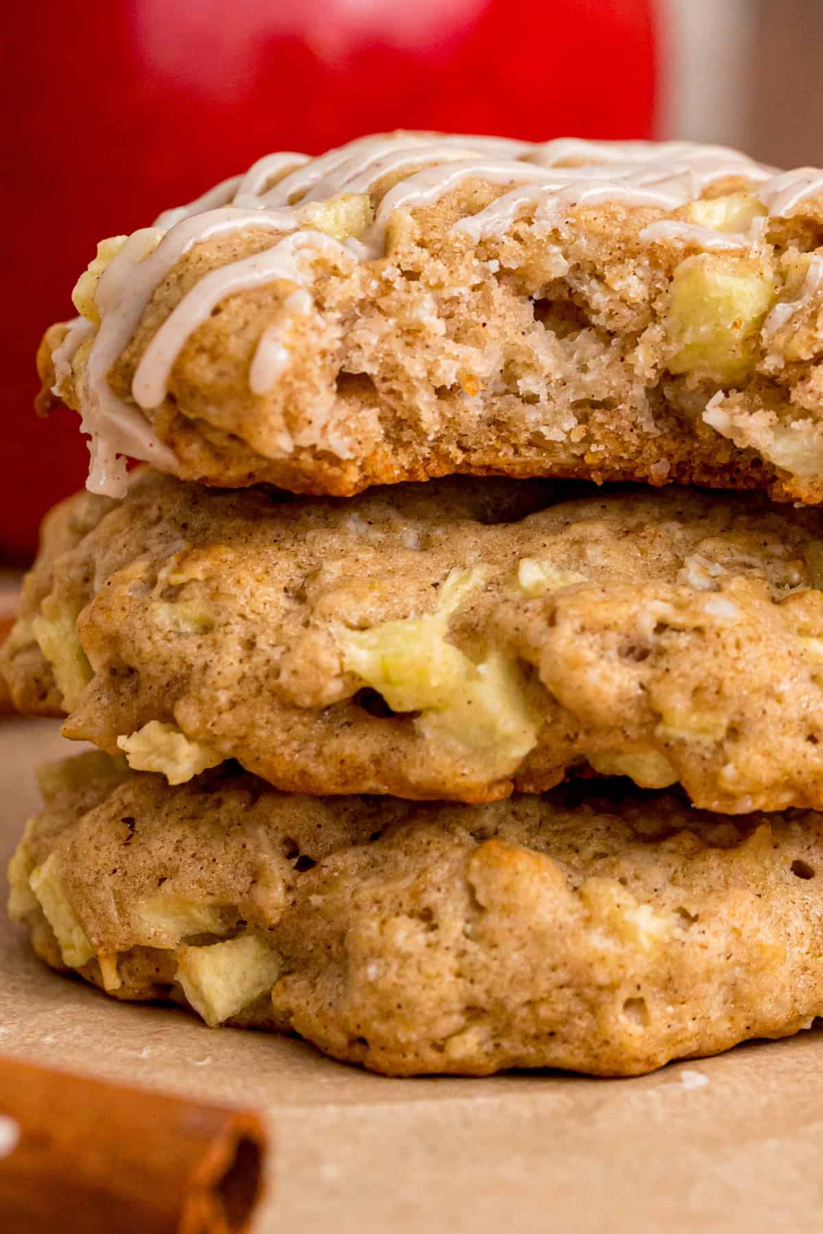 Soft, chewy oatmeal cookies are dotted with tart apples and topped with a sweet cinnamon glaze in these Apple Oatmeal Cookies. stacked apple oatmeal cookies