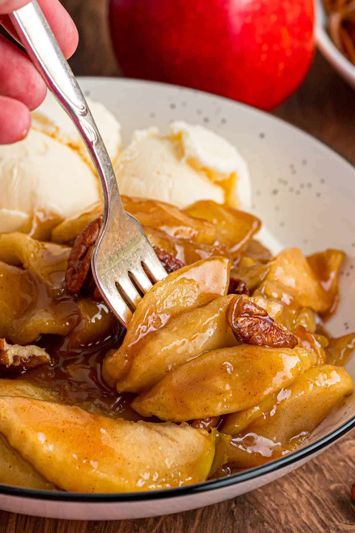 A fork in baked apple slices