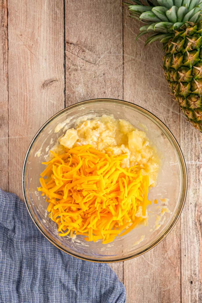 Pineapple and cheddar cheese in a bowl