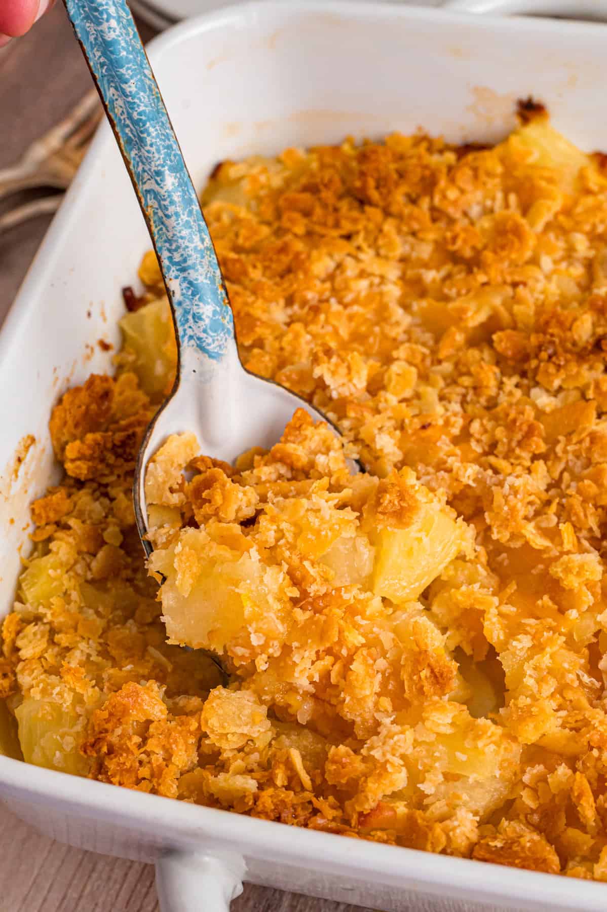 A spoon in pineapple casserole