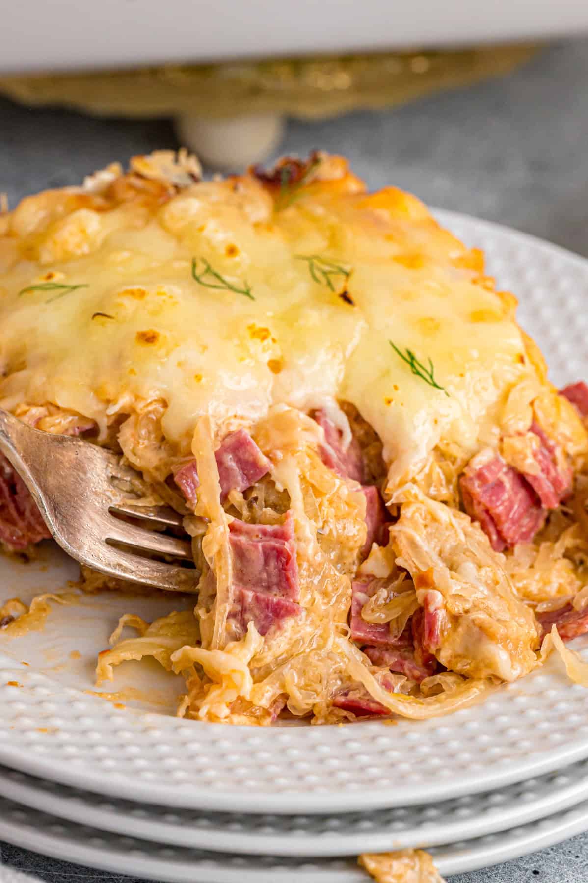 A fork in a slice of Reuben casserole
