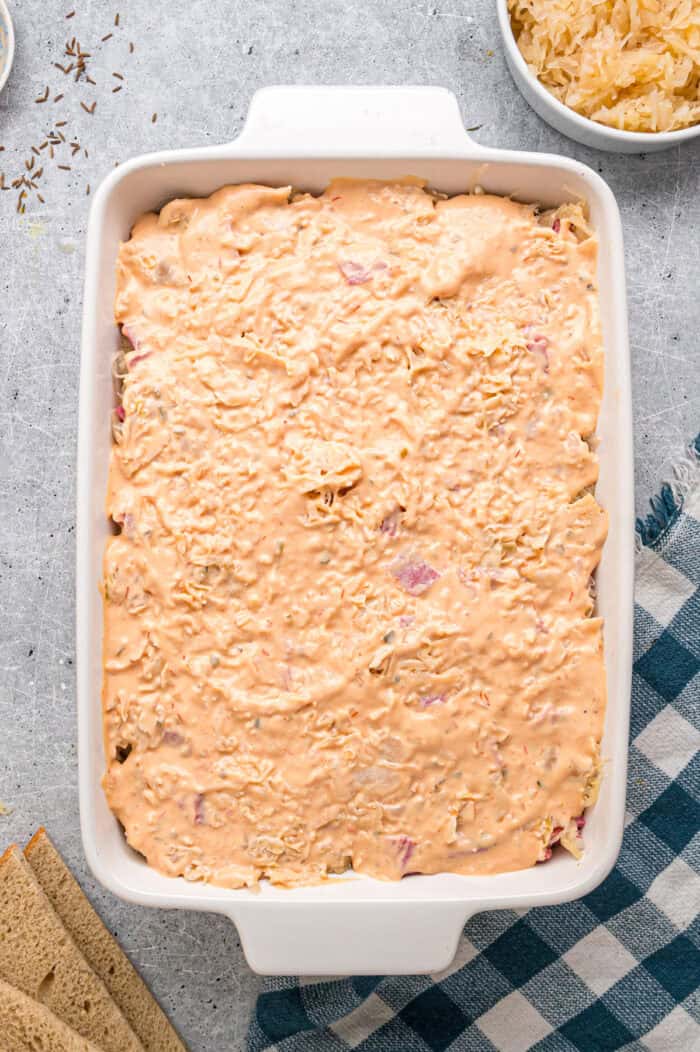 Thousand island dressing spread on layers of a casserole