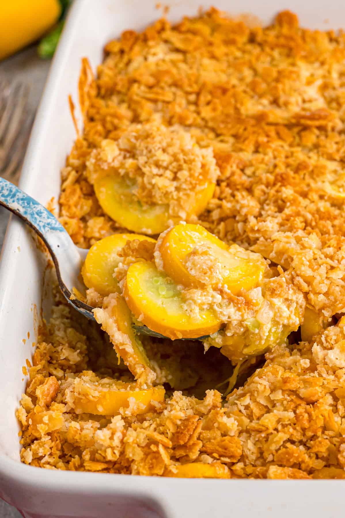 A spoon in serving Southern squash casserole