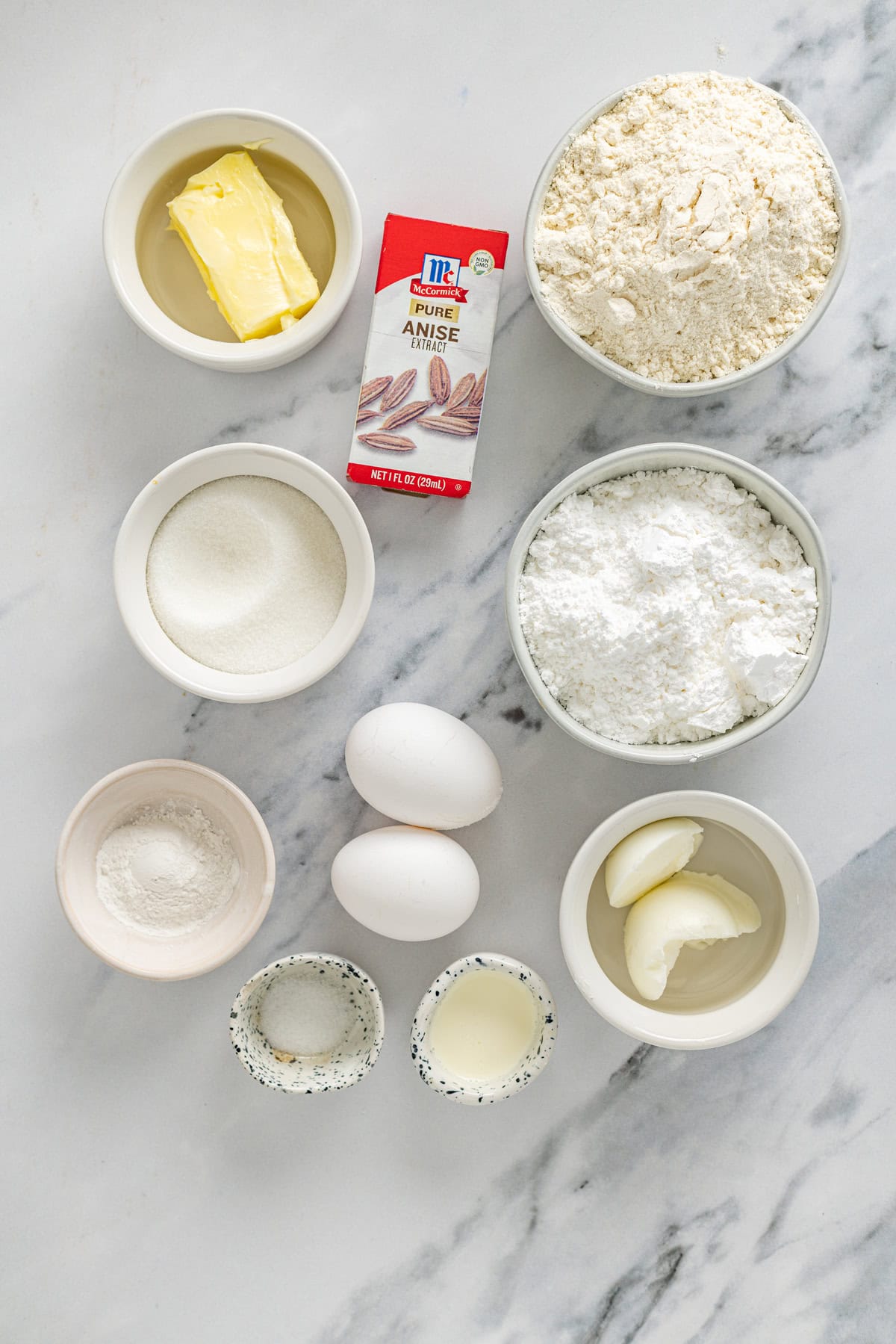 With a soft, buttery texture, the signature anise flavor, and simple decoration, these Anise Cookies are a holiday staple. Overhead view of ingredients needed to make anise cookies