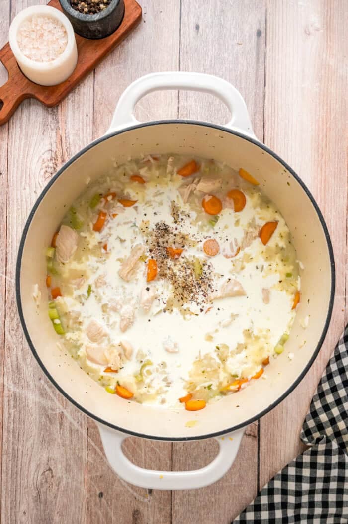 Ready in just under an hour, this Chicken and Rice Soup is quick, easy, and filling. Perfect for busy fall weeknights! Heavy cream stirred into broth
