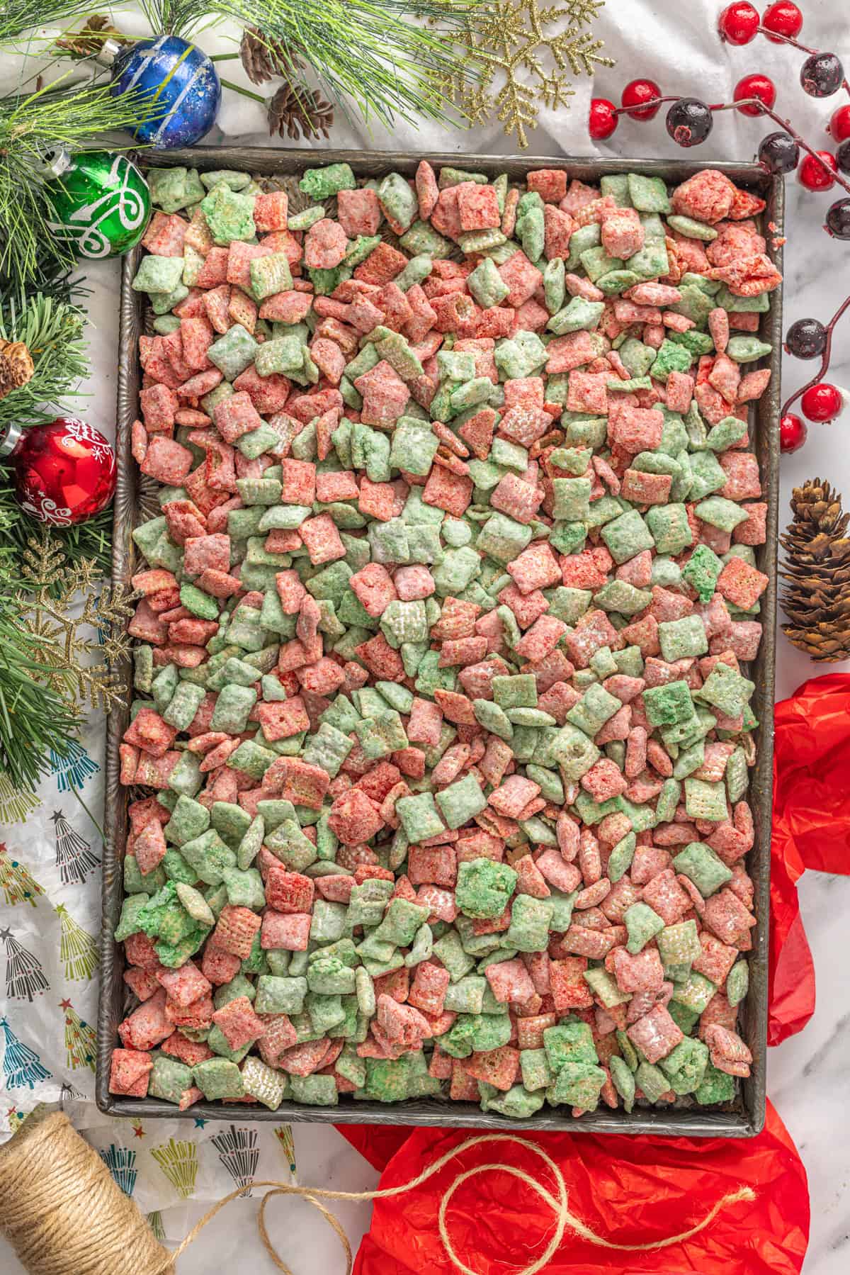 Red and green puppy chow out on a baking sheet