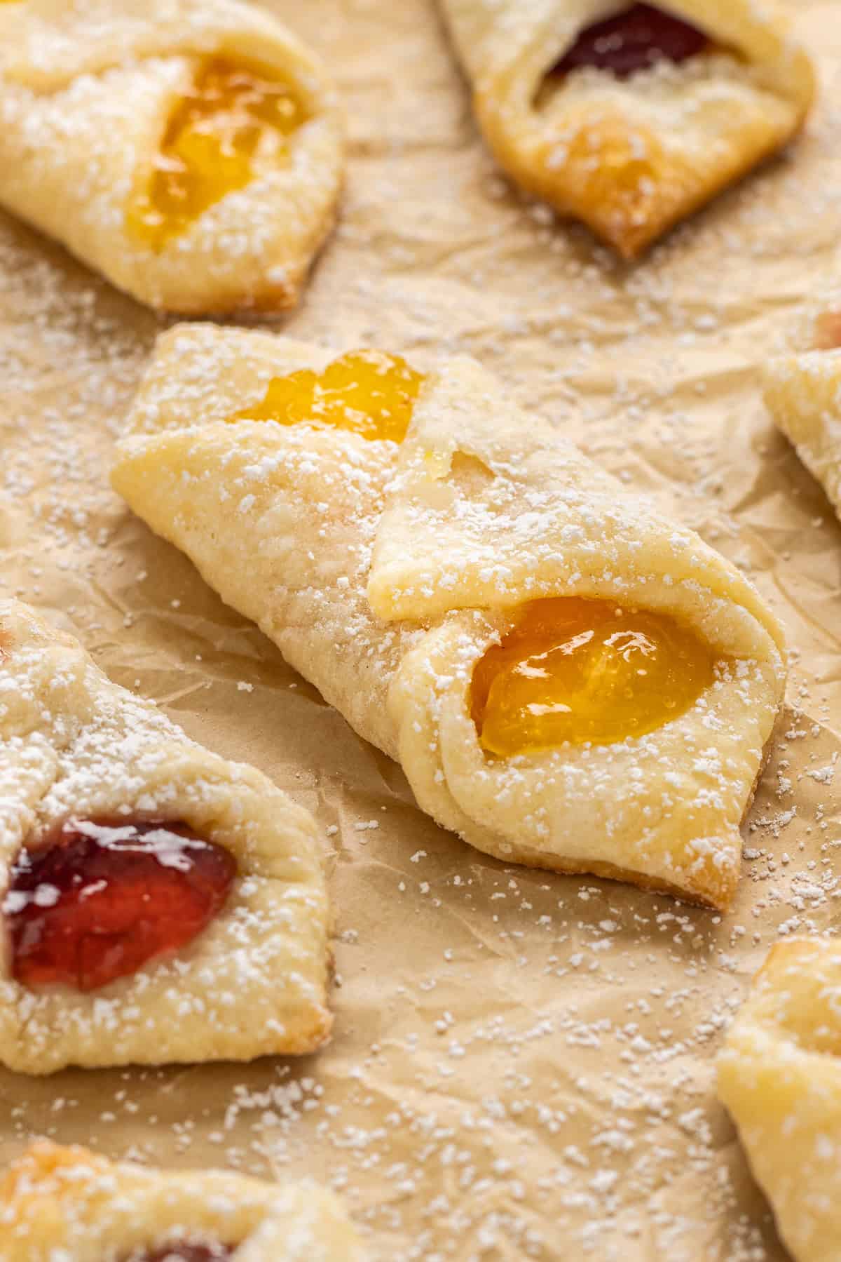 Kolaczki Cookies, aka Polish filled cookies, are made with a simple cream cheese dough and jam filling. They’re simple yet beautiful. Kolaczki cookies on a baking sheet